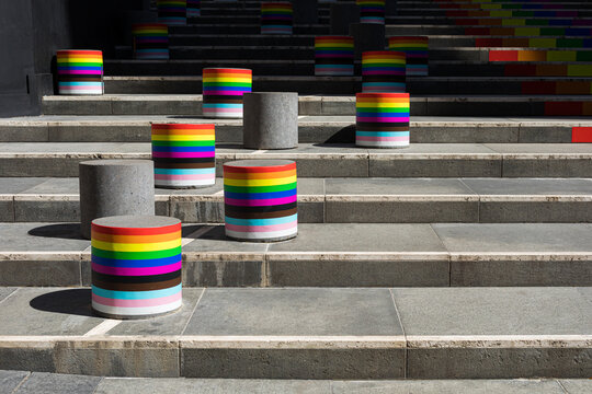 Cylinders on stairs painted with the LGBT community flag