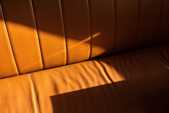 Brown leather couch with hard direct sunlight 