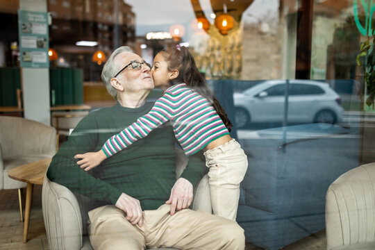 grandfather with his granddaughter in a restaurant