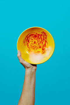 man holding a dirty plate with some soap foam