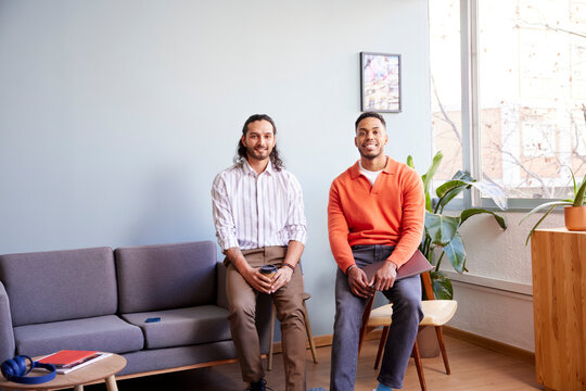 Smiling multiracial colleagues in modern workspace
