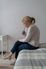 Depressed mature woman at home. Sad face with hands. Mental health problems, gaslighting or bulling...