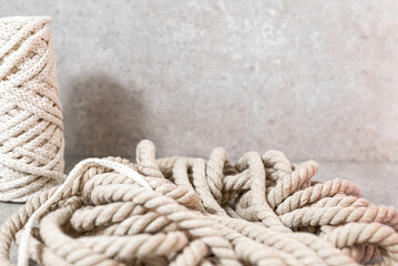 Fototapeta na wymiar Thick rope on a grey stone background