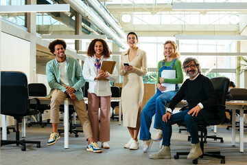 Group of diverse colleagues smiling in modern office