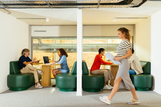 Group of colleagues discussing project in office