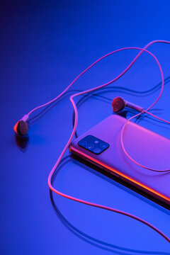 Detail of earphones and cellphone