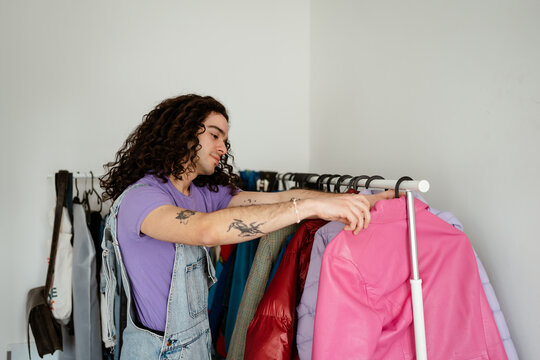 Man at home searcing for clothes to wear