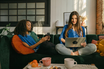 two young students on a sofa in living room 
