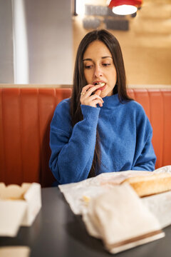 teenage girl having dinner in a restaurant