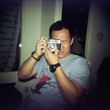 The man is taking pictures in front of the camera