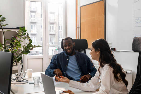 A Young Man And A Woman Work Together In An Office