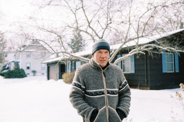 middle aged man in winter clothing outdoors after snow storm