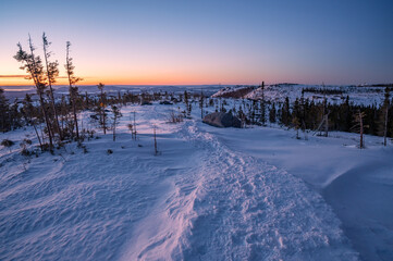 The famous Pioui trail on a cold winter morning as the sun rises, Grands-Jardins national park, Charlevoix, QC, Canada