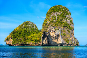 Fototapeta na wymiar Huge cliff rock in azure water, Ko Rang Nok, Ao Phra Nang Beach, Ao Nang, Krabi, Thailand