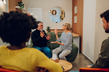 Senior people talking about their mental health on a group therapy session