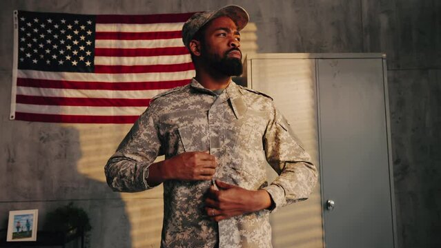 American soldier putting uniform on.