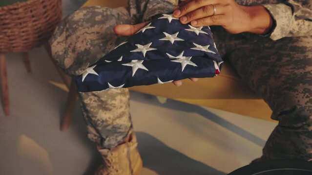 American soldier holding American flag in therapy.