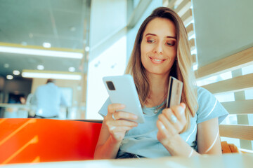 Happy Woman Making an Electronic Online Payment with an App. Cheerful customer transferring money via digital baking service 
