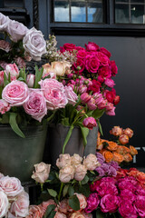 Bouquet of pink ranunculus and red rose. Decoration of the entrance of shop