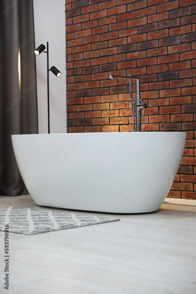 Canvas Prints Stylish bathroom interior with ceramic tub near brick wall