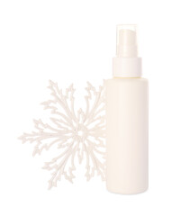 Bottle of hand cream and snowflake isolated on white. Winter skin care