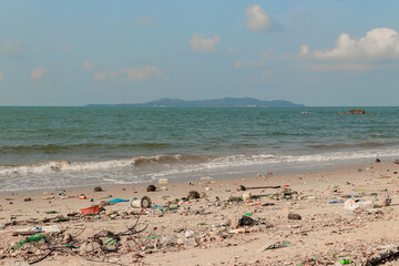 Beach pollution. plastic bottles and other trash on sea beach. Environmental pollution and ecological problem concept.