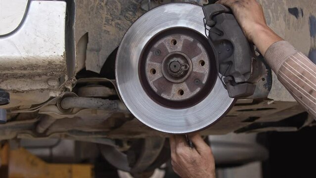 Repair of Car Brake Disc System in a Workshop Footage.