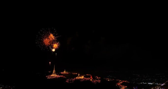 aerial view Beautiful fireworks light up the palace atop a hill in the heart of the city..Colorful lights decorate the palace and pagoda at the top of the mountain at night..colorful
