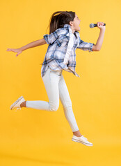 teen girl karaoke singer jumping in studio. teen girl karaoke singer on background.