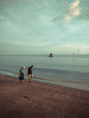 A couple walking at the beach in the morning.