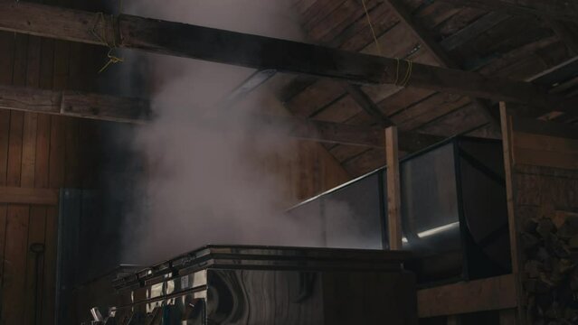 Steam From Maple Syrup On Evaporator Cooking Inside The Sugar Shack In Canada. - tilt down