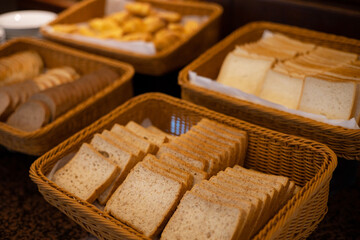 Several slices of bread placed in a brown basket.