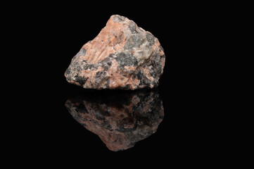 A fragment of the mineral granite with a granular structure