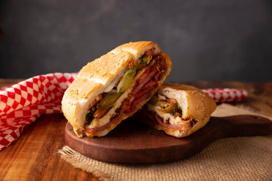 Mexican Torta. Sandwich made with common bread in Mexico, it can be telera, bolillo or bagette, split in half and filled with various ingredients, in this case spicy pork leg with Oaxaca cheese.