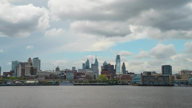 Philadelphia skyline timelapse with storm clouds moving over the calm Delaware River 