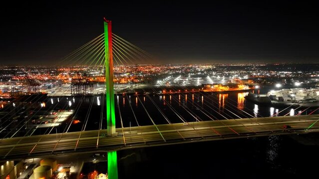 Night aerial of Gerald Desmond Bridge over the city lights of Long Beach, CA