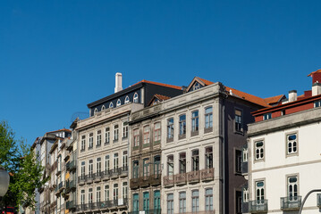 Fototapeta na wymiar Oporto, Portugal. April 13 , 2022: Alfandega neighborhood in front of the duero houses with architecture facades.