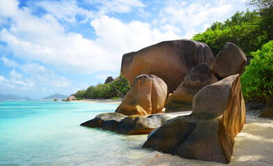 Anse Source d'Argent beach with big granite rocks in sunny day. La Digue Island, Indian Ocean, Seychelles. Tropical destination.