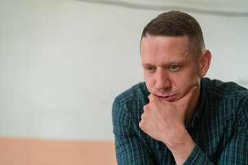 Portrait of a pensive caucasian man in a workshop. 