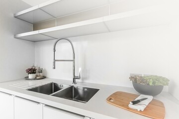 Fototapeta na wymiar Clean sink with white light in the kitchen, concept of cleanliness and hygiene in the home.