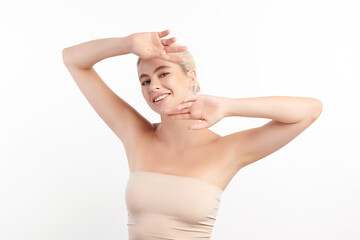 Obraz premium Beautiful Young woman lifting hands up to show off clean and hygienic armpits or underarms on white background, Smooth armpit cleanliness and protection concept