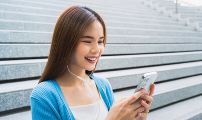 Woman using smartphone in public areas, During leisure time. The concept of using the phone is essential in everyday life.