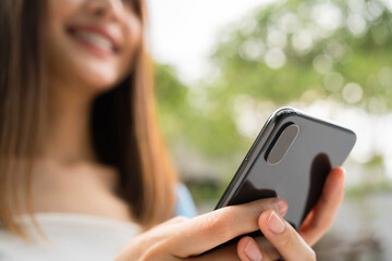 Woman using smartphone in public areas, During leisure time. The concept of using the phone is essential in everyday life.
