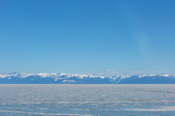 Frozen Lake and Snowy Mountains Winter Landscape
