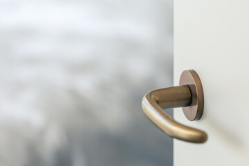 door handle on white door with copy space, antique brass lever handle for internal door, shallow depth of field