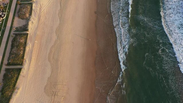 Aerial sunrise view over beach with Gold Coast Surfers Paradise cityscape