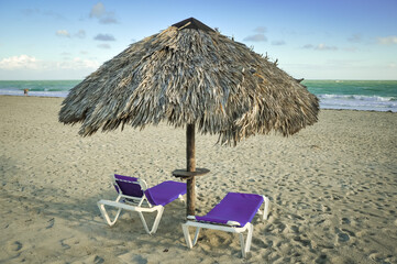 Empty beach chairs and umbrella on the beach