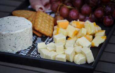 Cheese, crackers and grapes on a plate