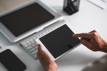 Close up of student hands using tablet for electronic learning. E-learning technology concept