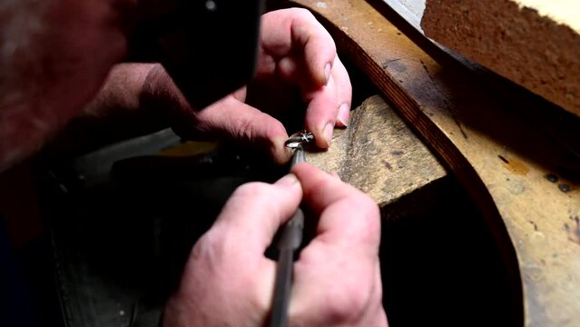 Gold wedding ring making by goldsmith, isolated, Jeweler melts gold in liquid state in crucible. Macro video. Craft jewelry making with professional tools. Process of making handmade. Metal melting